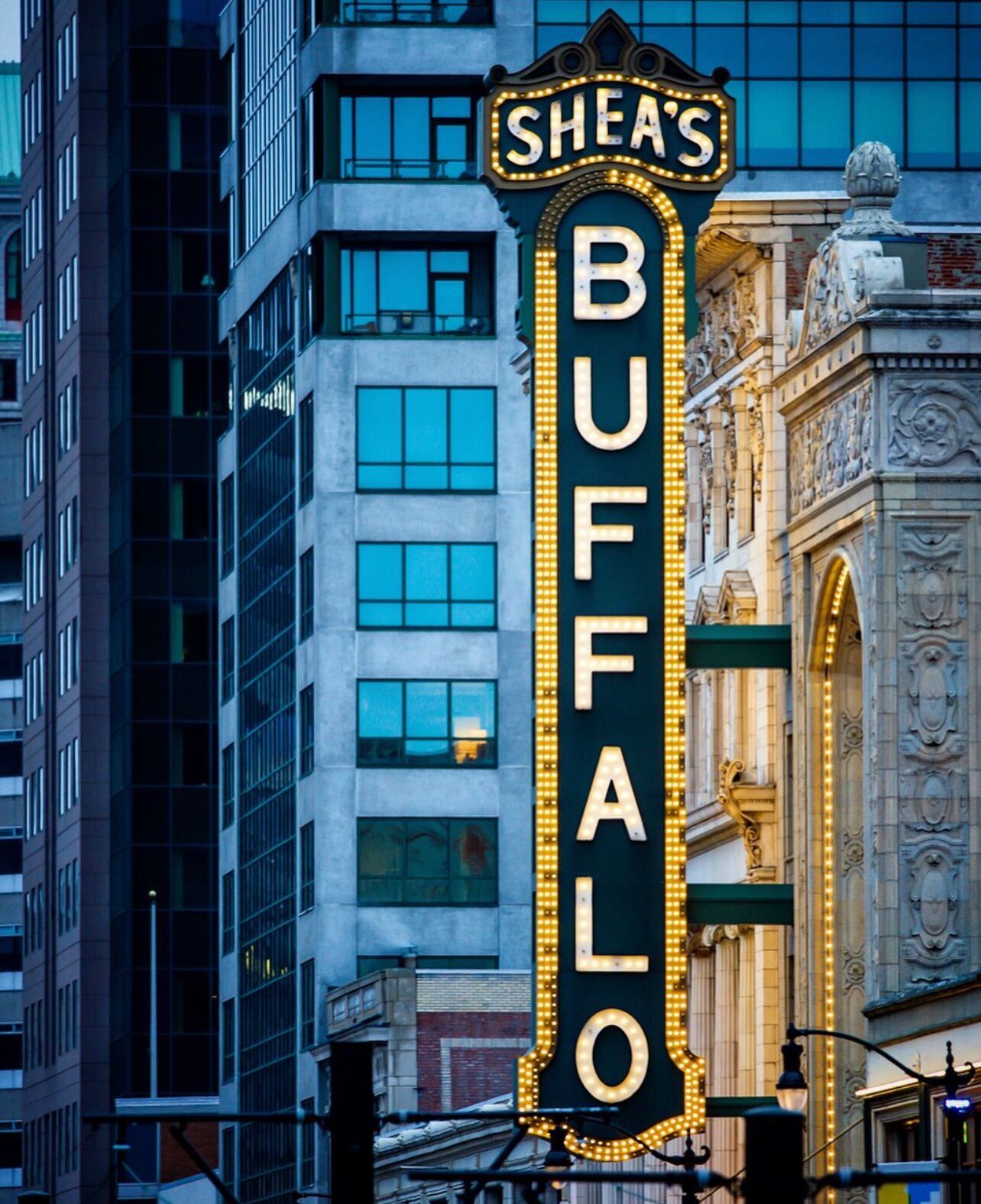 A theater marquee with "Shea's Buffalo" illuminated lights.