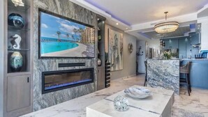 A modern kitchen with marble countertops, a built-in island, and a large island bar. - Dang This Place Fancy / Sonoran Sea / Sandy Beach / Beachfront End Unit (Puerto Peñasco)
