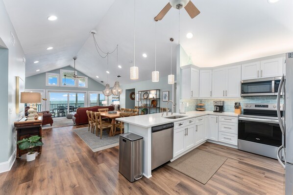 A spacious kitchen with modern appliances, a dining area with a view, and a cozy seating space.
