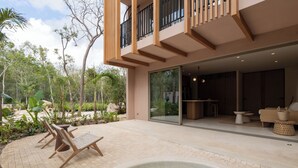 A modern house with a pool, outdoor seating, and a glass door leading to a living area. - Aflora Tulum  (Tulum)