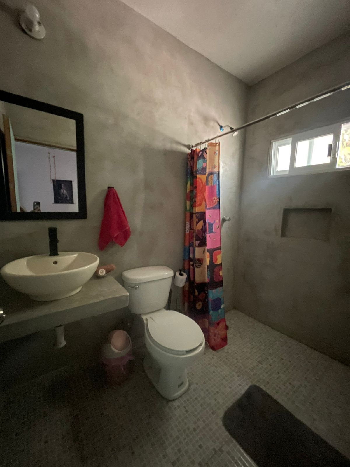 A bathroom with a white sink, toilet, and shower curtain.