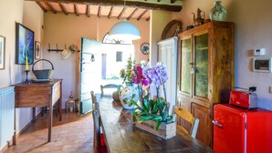 A rustic kitchen with wooden furniture, a red refrigerator, and a variety of decorative items. - Beautiful home in Siena with WiFi (Siena)
