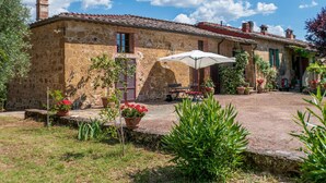 A rustic stone building with a tiled roof, outdoor seating, and potted plants. - Beautiful home in Siena with WiFi (Siena)