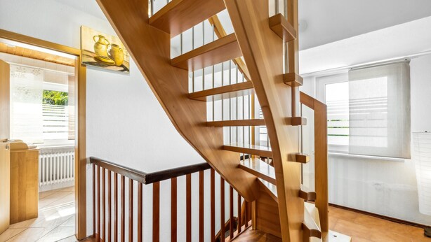 A wooden staircase with a black railing, leading to an upper floor. - Nice home in Tossens with WiFi (Tossens)
