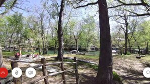 A park with a wooden fence, trees, and a small pond. - Cozy family fish camp on the Little Red River, a premier trout fishing stream! (Pangburn)