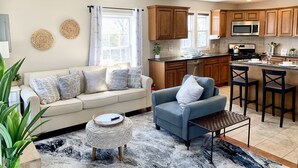 A modern kitchen with wooden cabinets, a built-in microwave, and a gas stove.