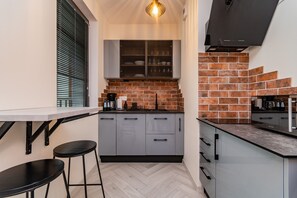 Mini-fridge, dishwasher, espresso maker, cookware/dishes/utensils