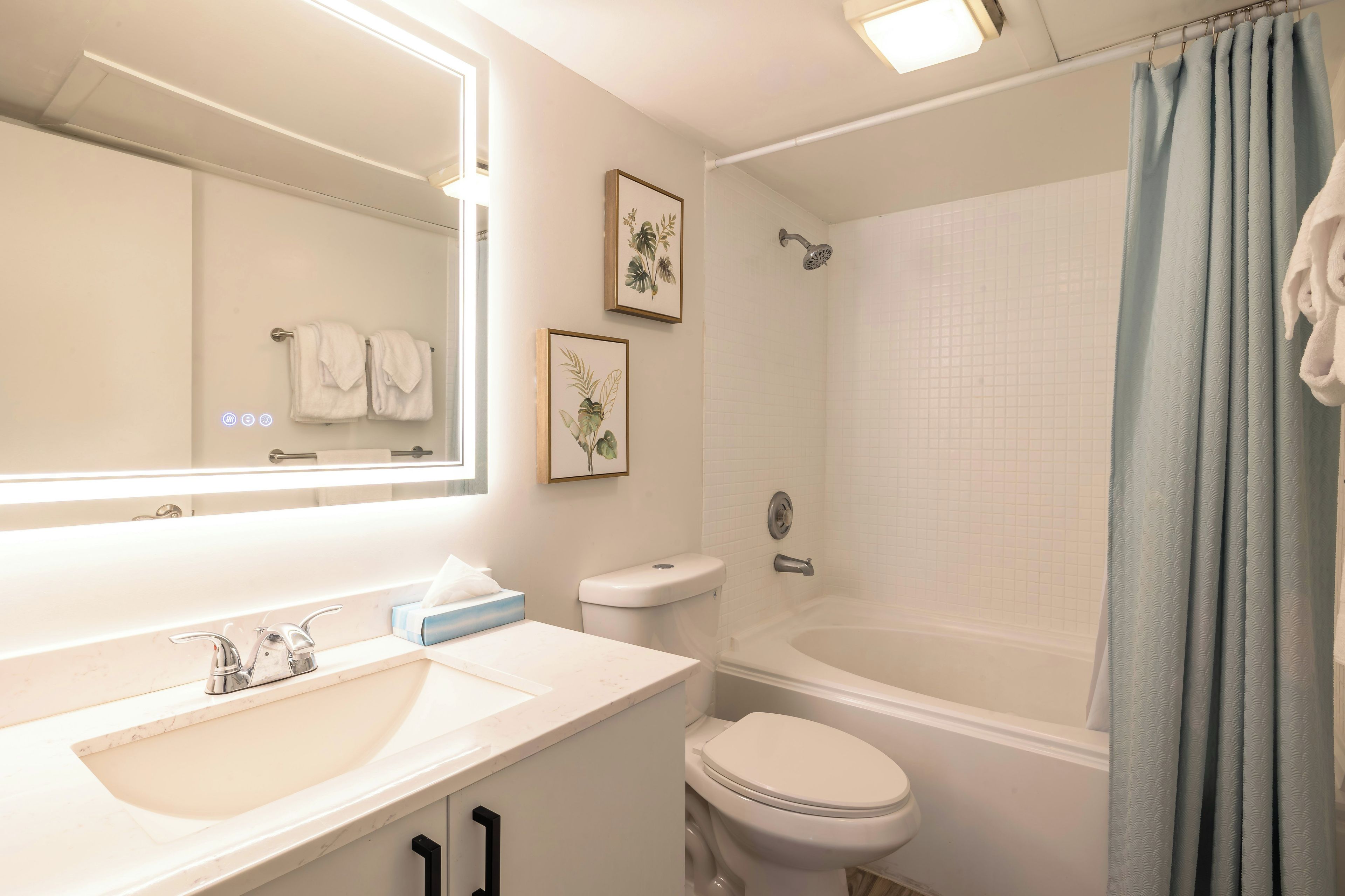 A bathroom with a sink, toilet, and bathtub.