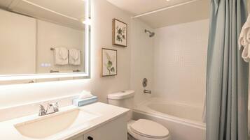 A bathroom with a sink, toilet, and bathtub.