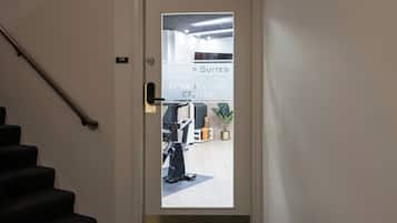 A door with a frosted glass panel and a sign indicating 'B SHOP SUITES AT THE EXECUTIVE CENTRE FITNESS & FUN CENTER'.