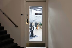 A door with a frosted glass panel and a sign indicating 'B SHOP SUITES AT THE EXECUTIVE CENTRE FITNESS & FUN CENTER'. - Bishop Suites Downtown Honolulu (Honolulu)
