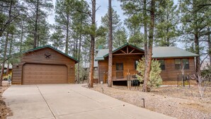 A log cabin with a garage, a covered porch, and a small deck. - Torreon Cardinal Landing Cabin With Party Garage (Show Low)