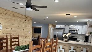 A modern kitchen with a dining area.