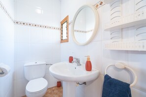 A bathroom with a toilet, sink, mirror, and towel rack. - Holiday Home 'Casa Del Practicant' with Mountain Views, Private Terrace and Private Garden (Culla)