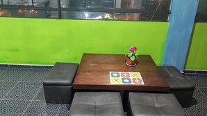 A seating area with a table, a potted plant, and a view of the city through a window. - 10 minutes walking to the Cusco Main square  (Cusco)