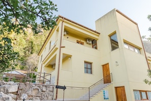 A multi-story building with a staircase, a balcony, and a sign indicating 'ARTIFACTS.'