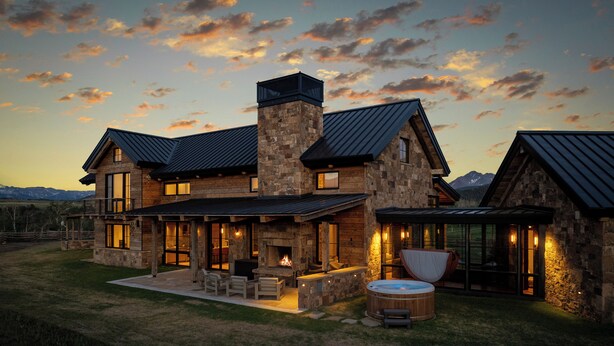 A large stone house with a fireplace, outdoor seating, and a hot tub. - Telluride Ranch / Mountain Views, Hot Tub & Fire Pit (Placerville)