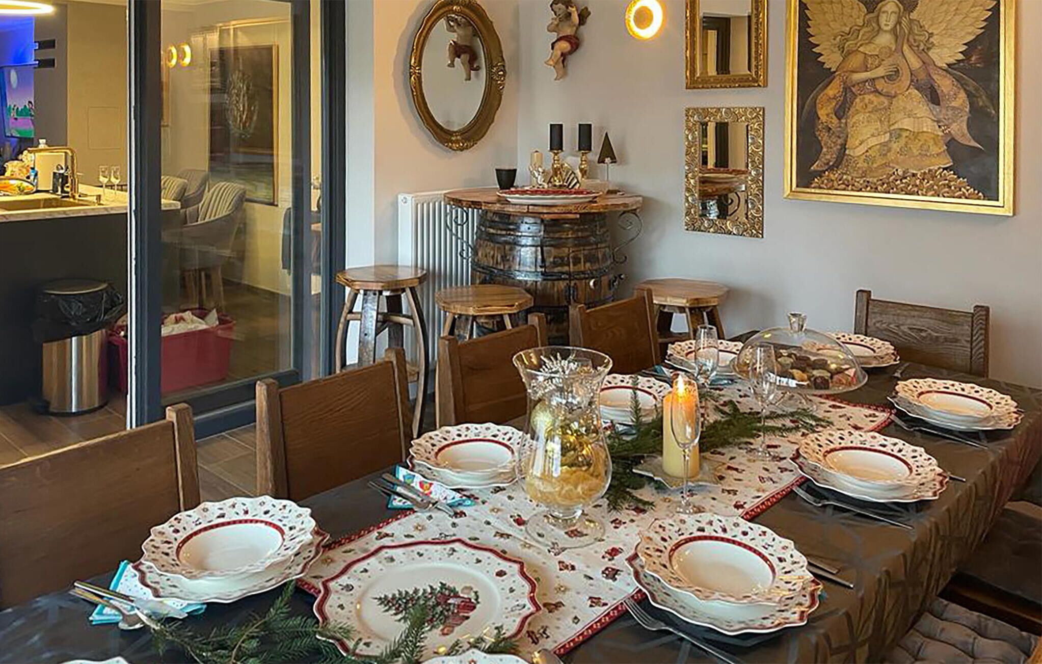 A dining area with a long table set for a meal, surrounded by chairs.