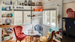 A cozy kitchen with wooden cabinets, a dining table, and two chairs.