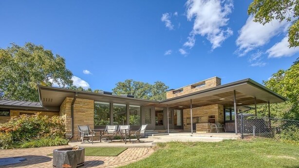 A modern house with a patio, outdoor seating, and a fire pit. - Midcentury beauty with modern updates, gorgeous views (Grafton)
