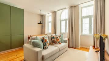 Relax in this inviting living room with a sofa, coffee table, and flat-screen TV.