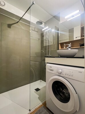 Shower, hair dryer, towels, soap