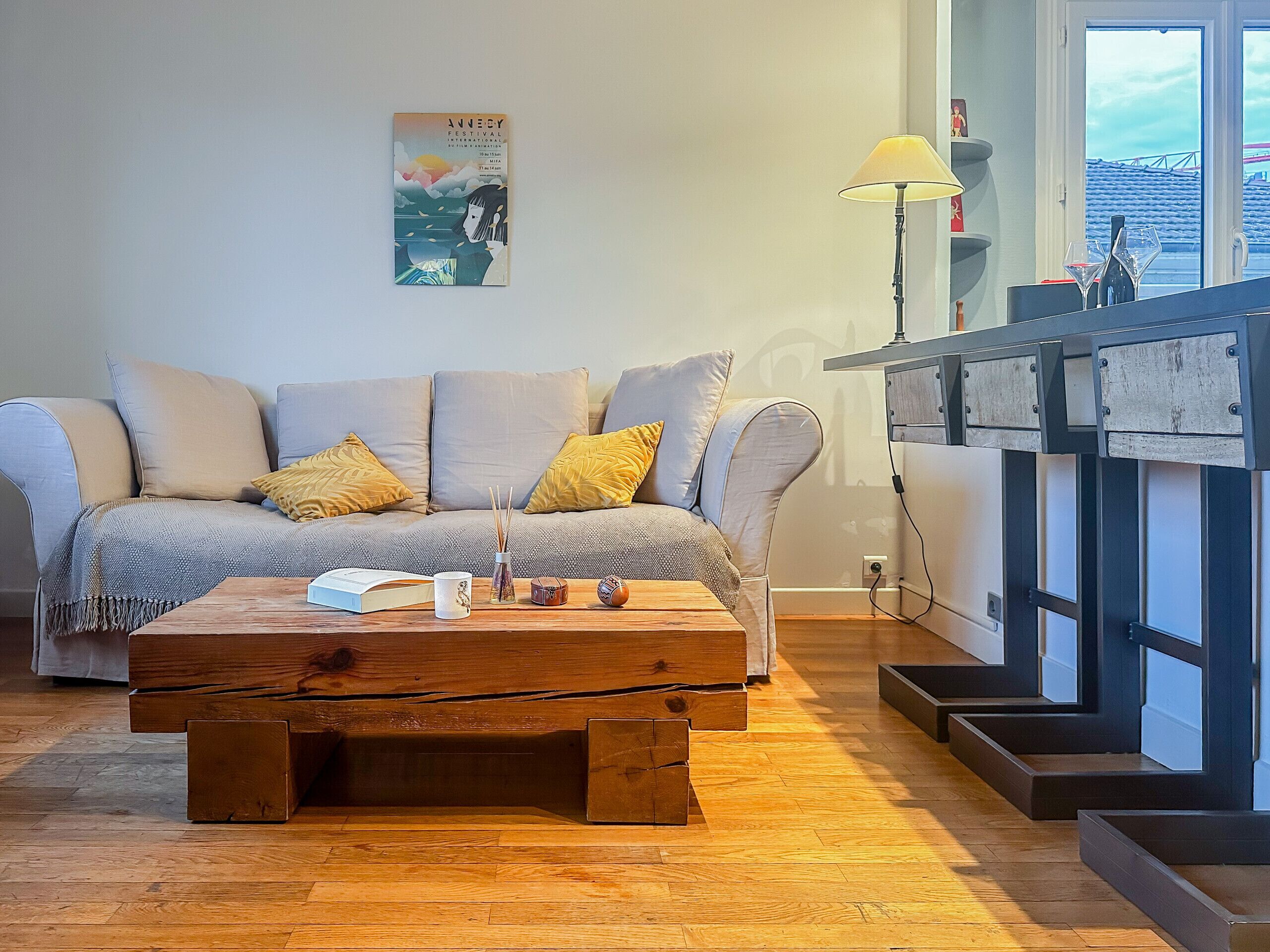 A living room with a sofa, coffee table, and a fireplace.