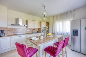 A modern kitchen with white cabinets, a wooden island, and a stainless steel refrigerator. - Hedonistic Vineyard Estate with Hot Tub, Ludbreg, Croatia (Ludbreg)