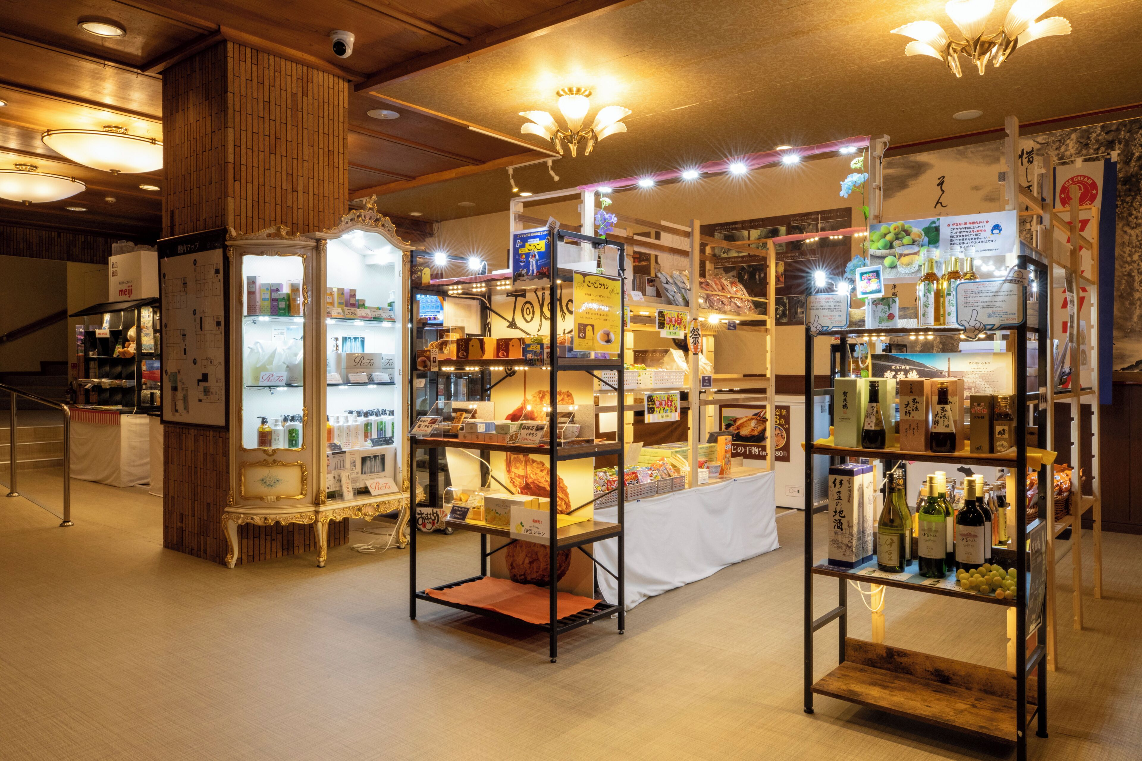 A well-lit store with multiple shelves stocked with various products, including beverages and packaged goods.