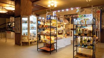 A well-lit store with multiple shelves stocked with various products, including beverages and packaged goods.