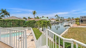 A residential area with a swimming pool, a dock, and a marina. - 5BR Lush Marco Island Retreat (Marco Island)