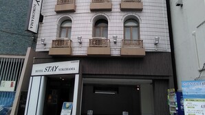 A multi-story hotel with a tiled facade and balconies. The hotel's name is displayed on the entrance.