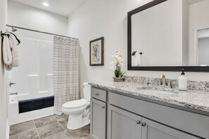 A modern bathroom with a shower, toilet, and vanity. - Pet-Friendly 2BR Greer Home, King Beds & Fire Pit (Greer)
