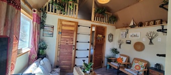 Cozy tiny cabin nested in the trees in a lake community, peaceful countryside.
