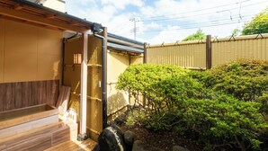 A traditional Japanese-style building with a wooden deck and a bamboo fence. - IKONASOU (Izunokuni)