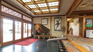 A traditional Japanese interior with tatami flooring, a wooden staircase, and a shoji screen door. - IKONASOU (Izunokuni)