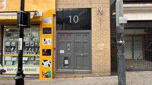 A storefront with a 'BUY'S REPAIR' sign, a 'LEATHER GOODS' sign, and a door labeled '10'. - Sleeps 2 Studio -central Croydon London -wifi & Tv (Croydon)