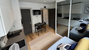 A modern apartment with a dining area, kitchen, and a large sliding glass door leading to a balcony. - Sleeps 2 Studio -central Croydon London -wifi & Tv (Croydon)