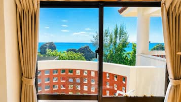 A room with a view of the ocean and rocky outcrops.