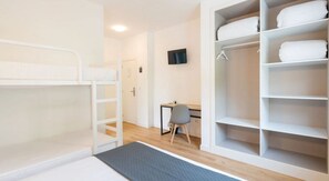 A room with bunk beds, a desk, a chair, and a wardrobe with shelves. - Alda Via Norte (O Grove)