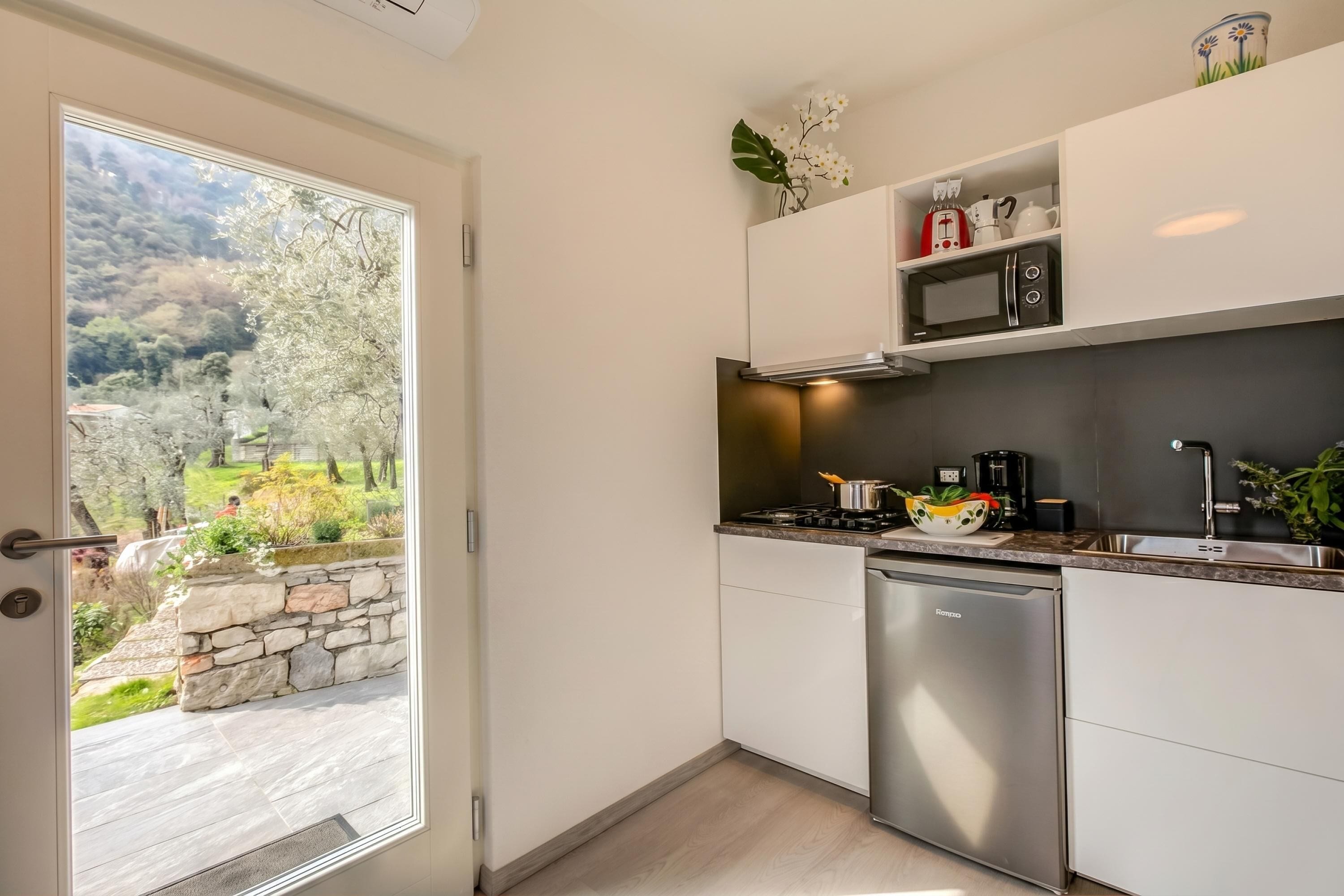 Family House, Multiple Bedrooms (Relais Nanzello Garda Living 2) | Private kitchen | Fridge, microwave, stovetop, coffee/tea maker