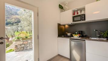 Family House, Multiple Bedrooms (Relais Nanzello Garda Living 2) | Private kitchen | Fridge, microwave, stovetop, coffee/tea maker