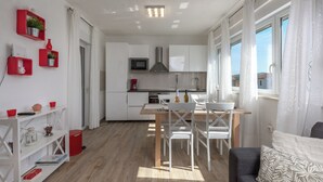 A modern kitchen with white cabinets, a microwave, and a stainless steel range hood. - Asteria Villa With Private Pool - Labin (Labin)