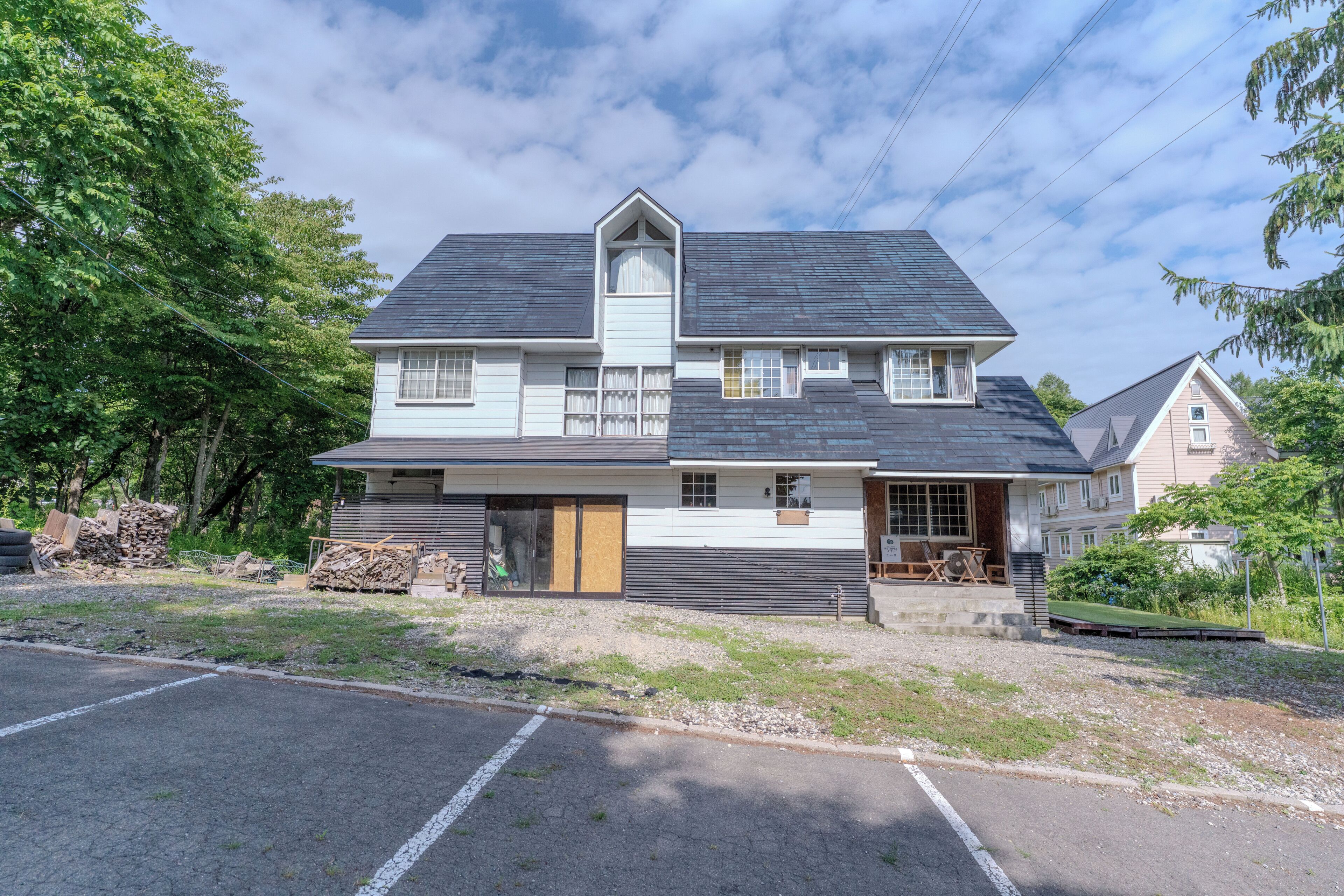 A two-story house with a gabled roof, a front porch, and a garage.
