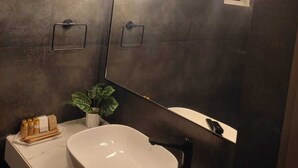 A modern bathroom with a large mirror, a white sink, and pendant lights. - Goan Fiesta Ultra Luxury Suite Calangute (Calangute)