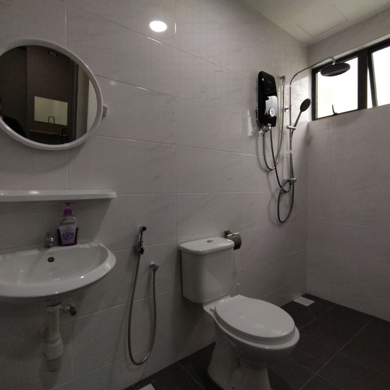 A bathroom with a sink, toilet, and shower.