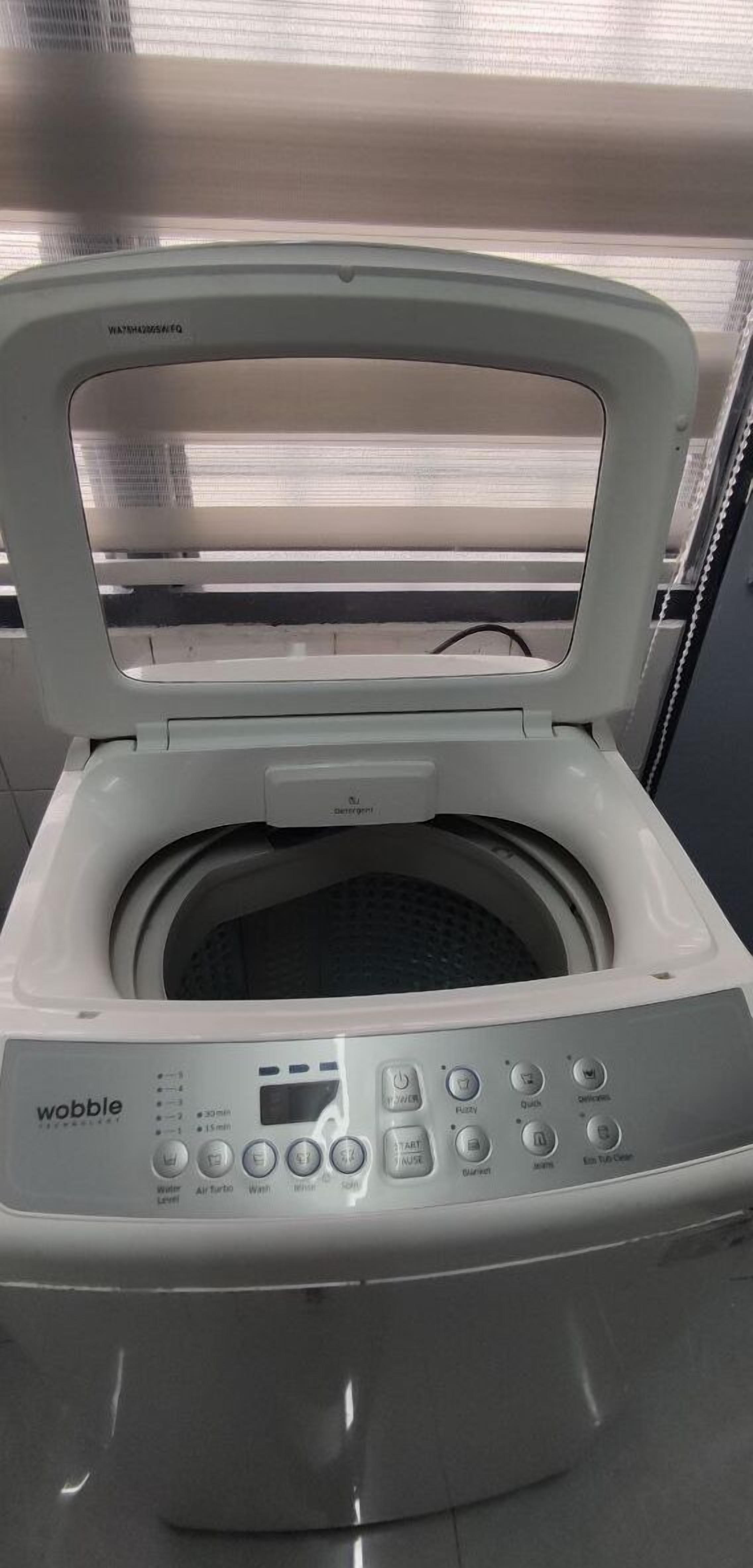 A Wobble portable washing machine with a digital display, control panel, and a transparent door.