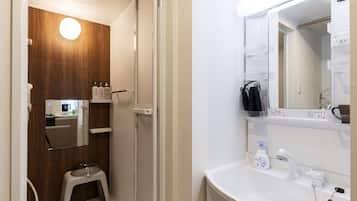 A modern bathroom with a shower, toilet, and sink.