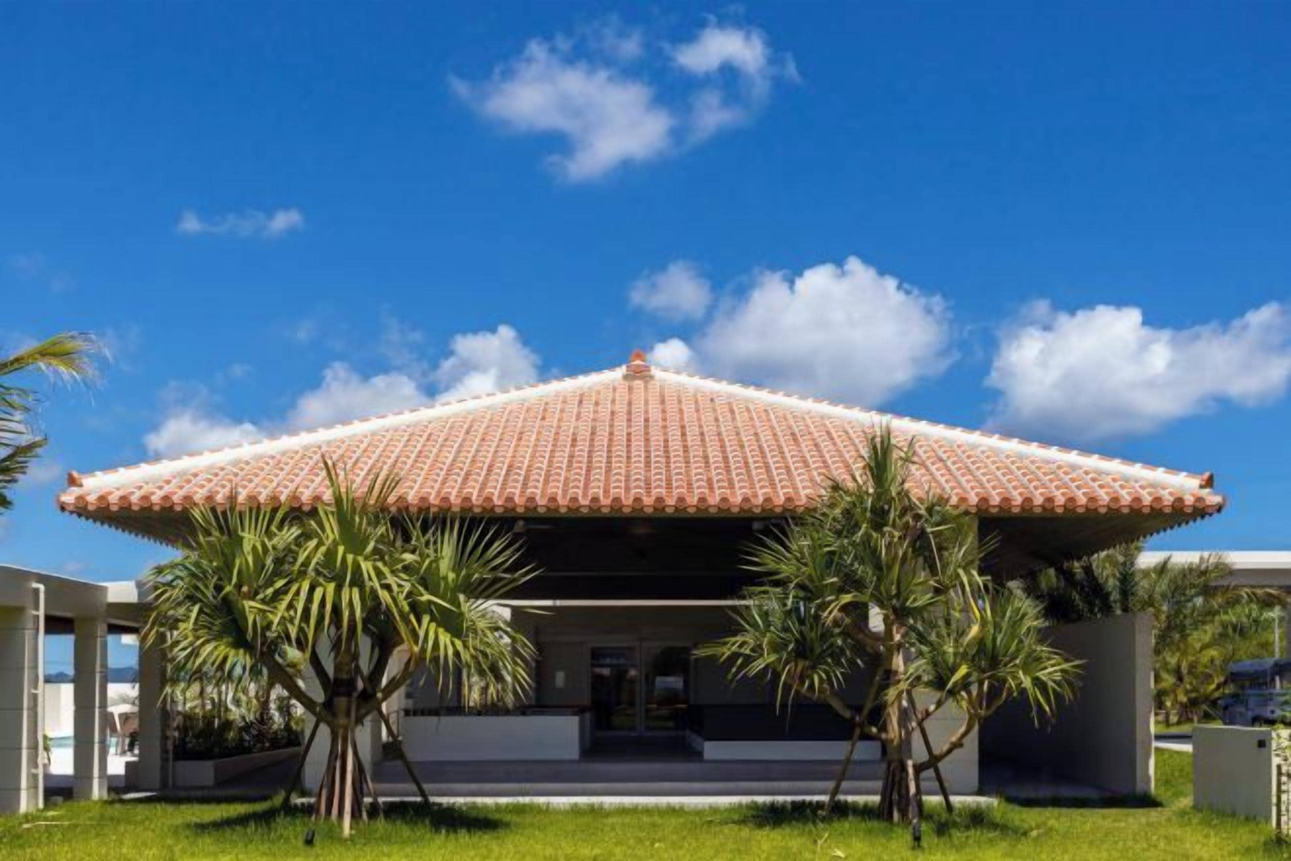 A building with a red-tiled roof and a covered entrance.