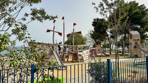A playground with slides, climbing structures, and a fenced area. - Athenian Riviera Vari next to the beach (Vari)